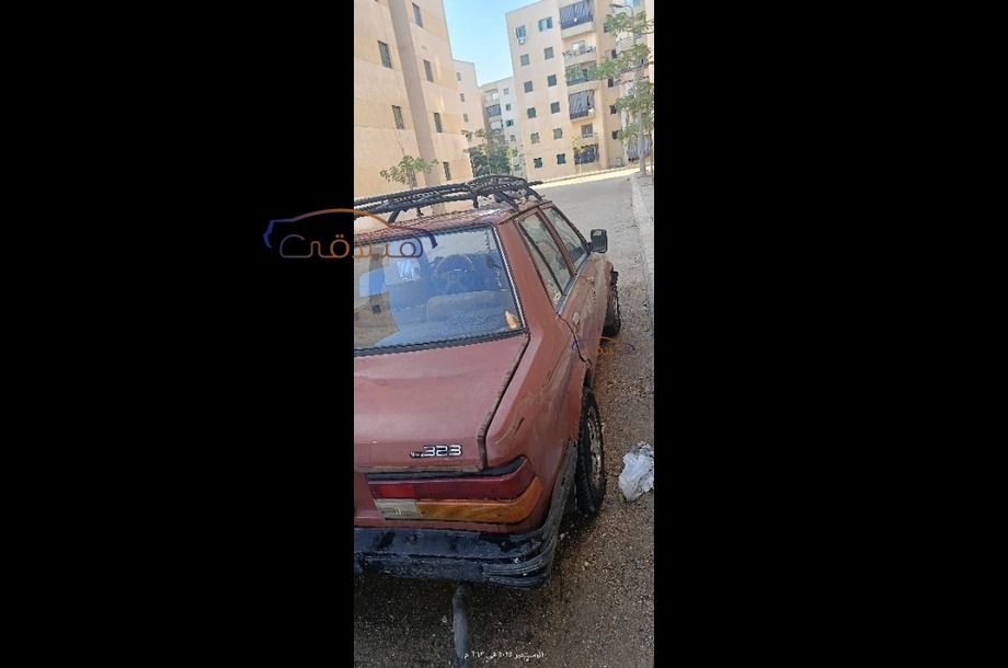 323 Mazda احمر غامق